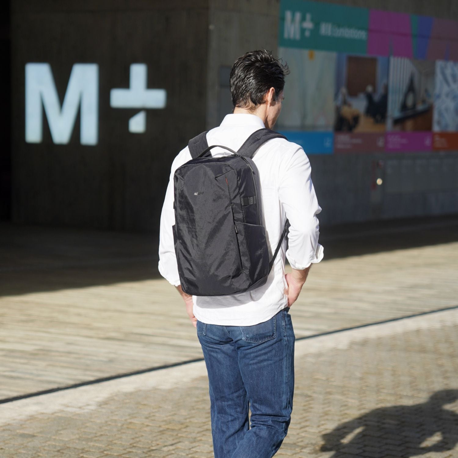 Model wearing the ADD1D D2D Essential 22L lightweight backpack during urban commute