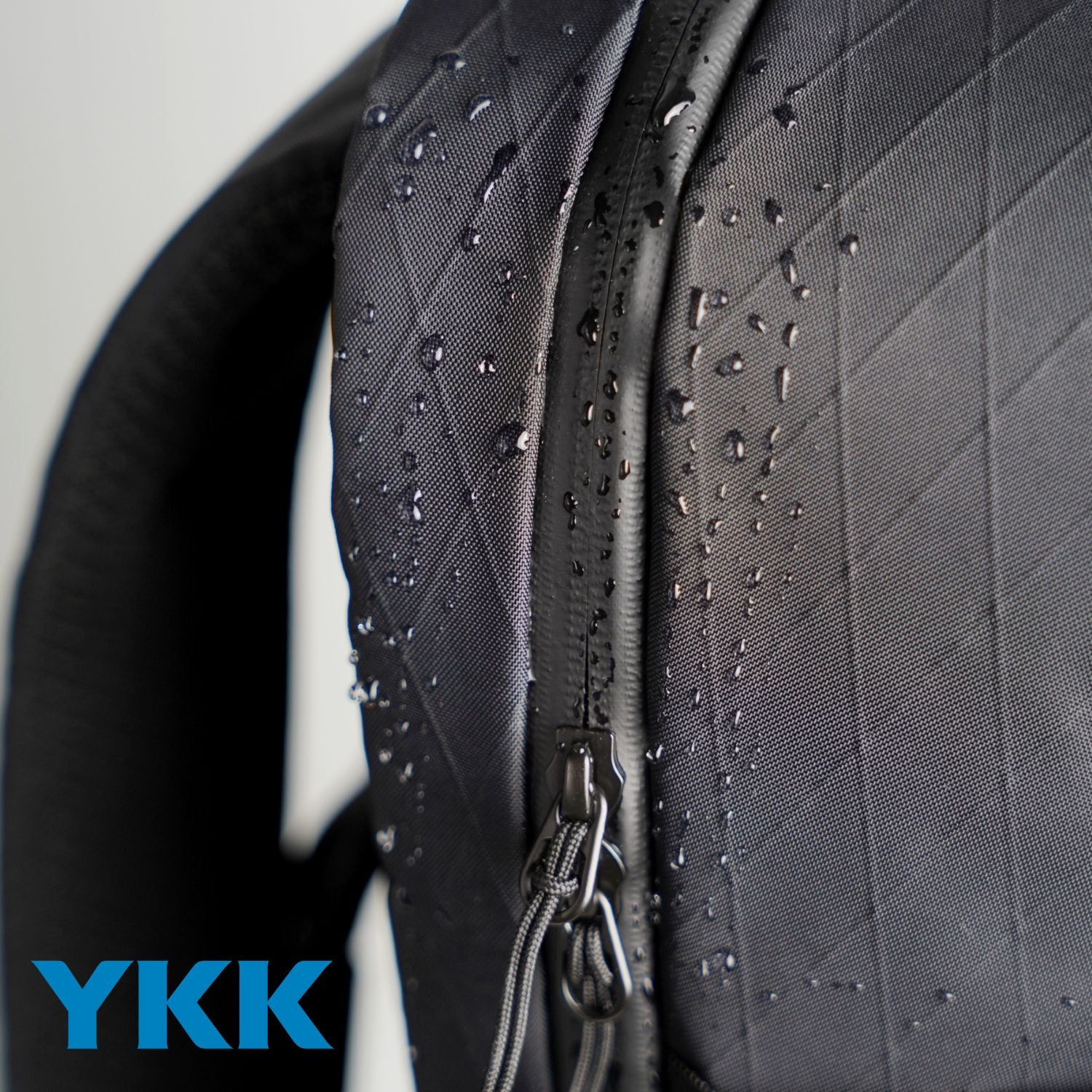 Close-up detail of waterproof X-Pac VX21 fabric and YKK AquaGuard zipper on ADD1D D2D Essential Pack
