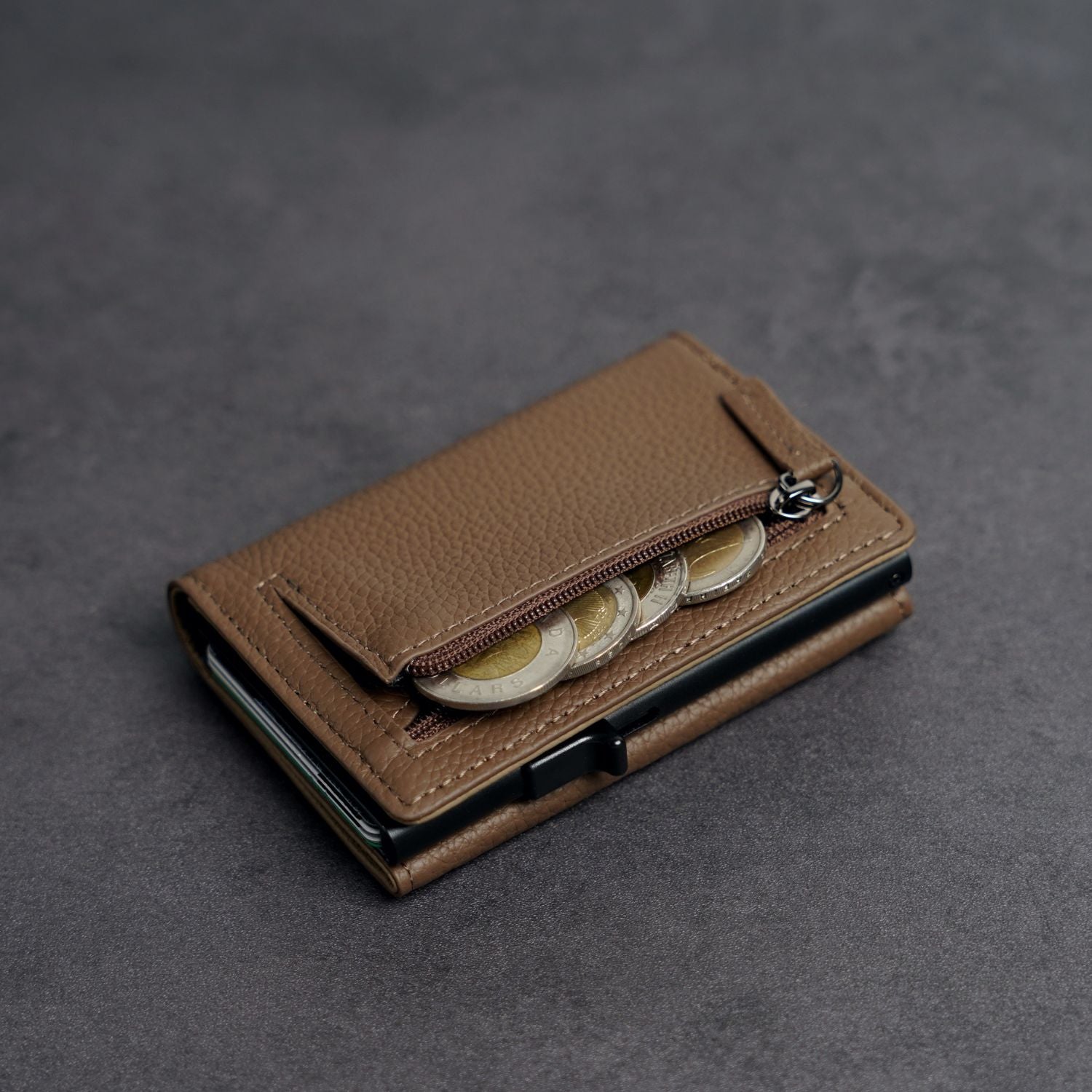 Close-up detail of full-grain pebbled leather grain and heavy-duty zipper on ADD1D Explorer Wallet Large