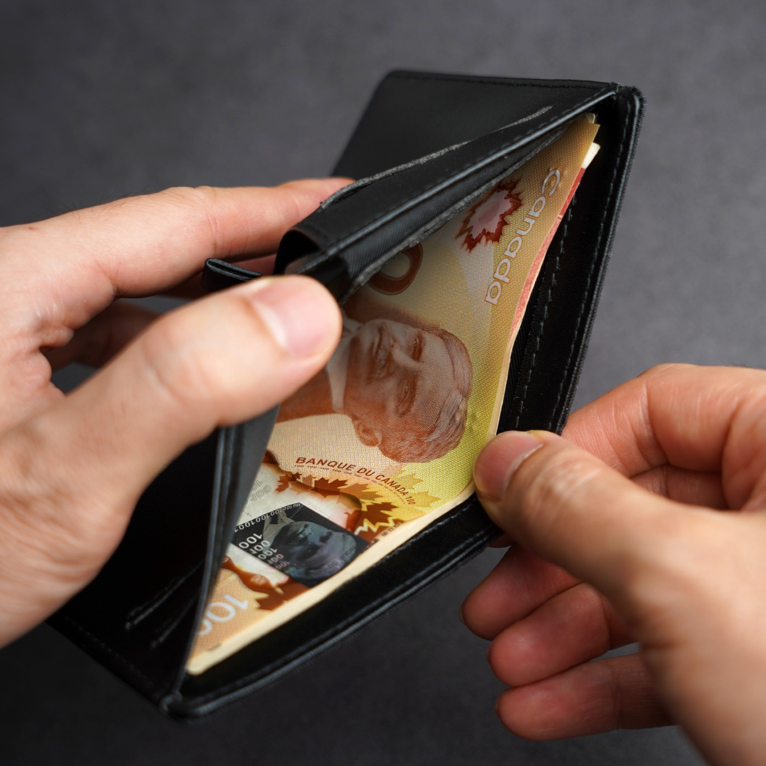 External quick-access pocket holding folded bills on ADD1D Explorer Wallet S
