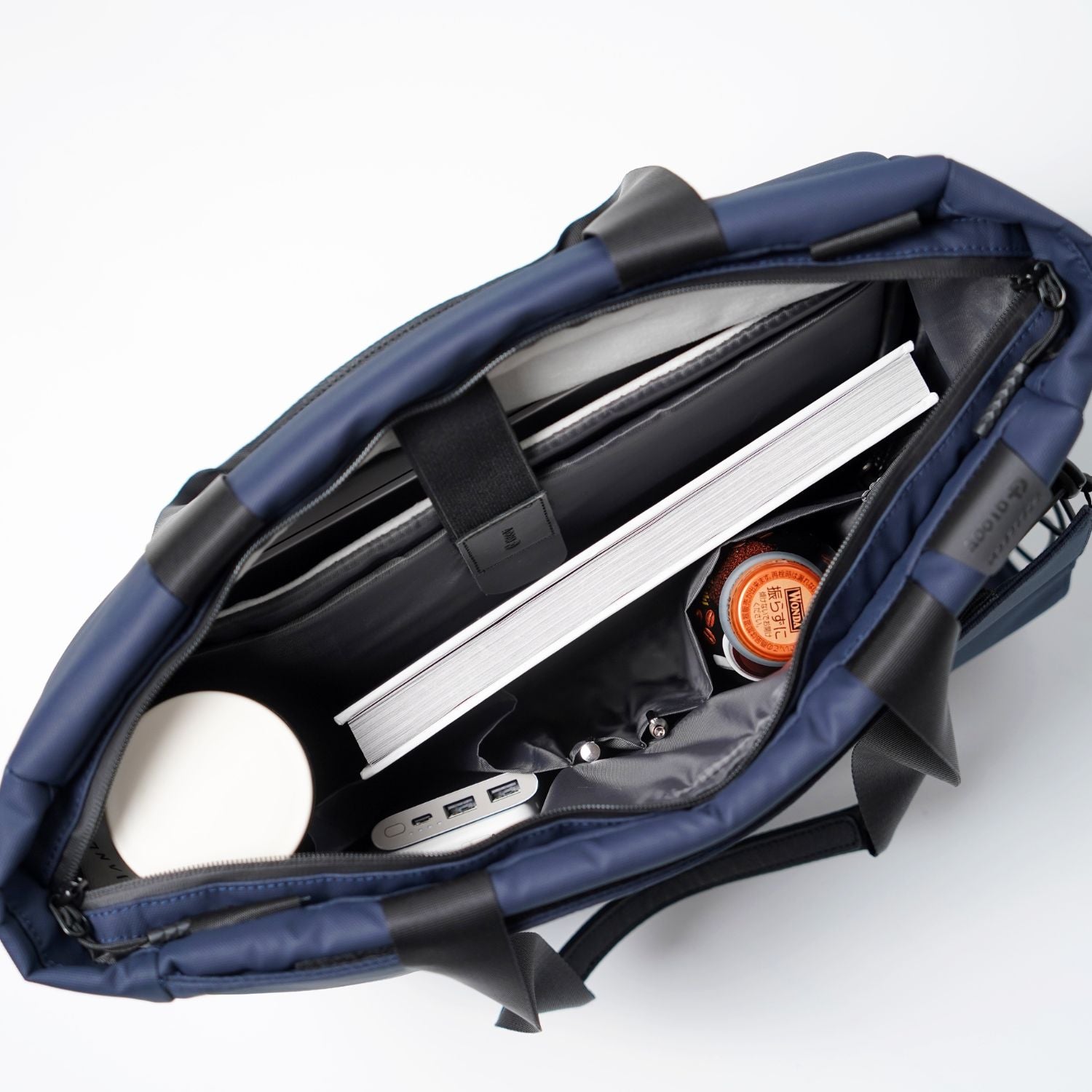 Open main compartment of ADD1D Kangaroo Messenger Tote featuring padded laptop sleeve and organization pockets