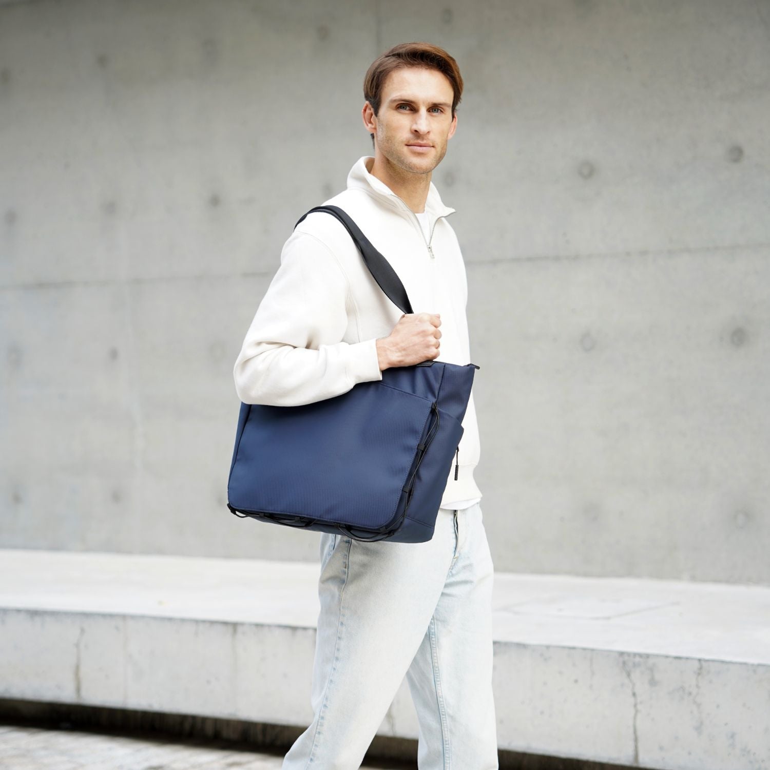 Model carrying the ADD1D Kangaroo Messenger Tote as an urban EDC laptop shoulder bag