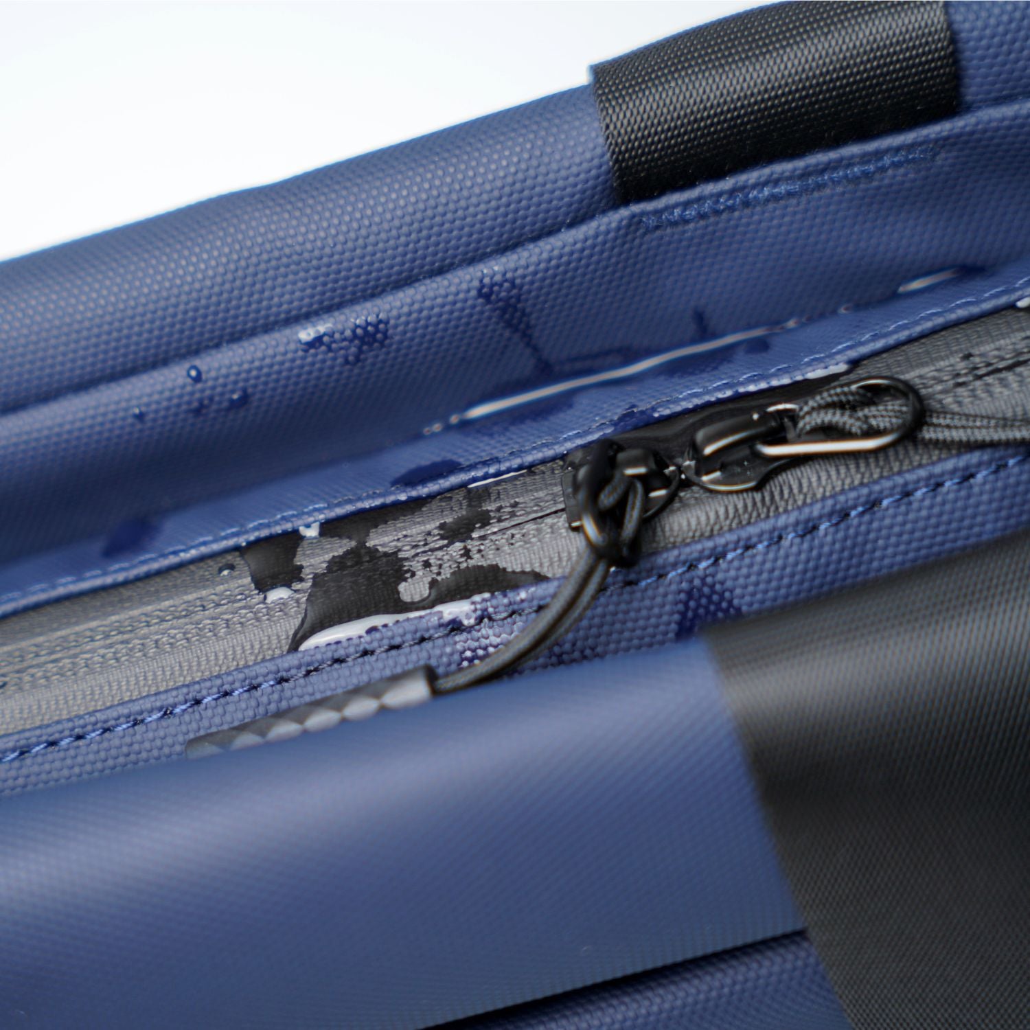 Close-up detail of weather-resistant 900D fabric and YKK zippers on ADD1D Kangaroo Messenger Tote