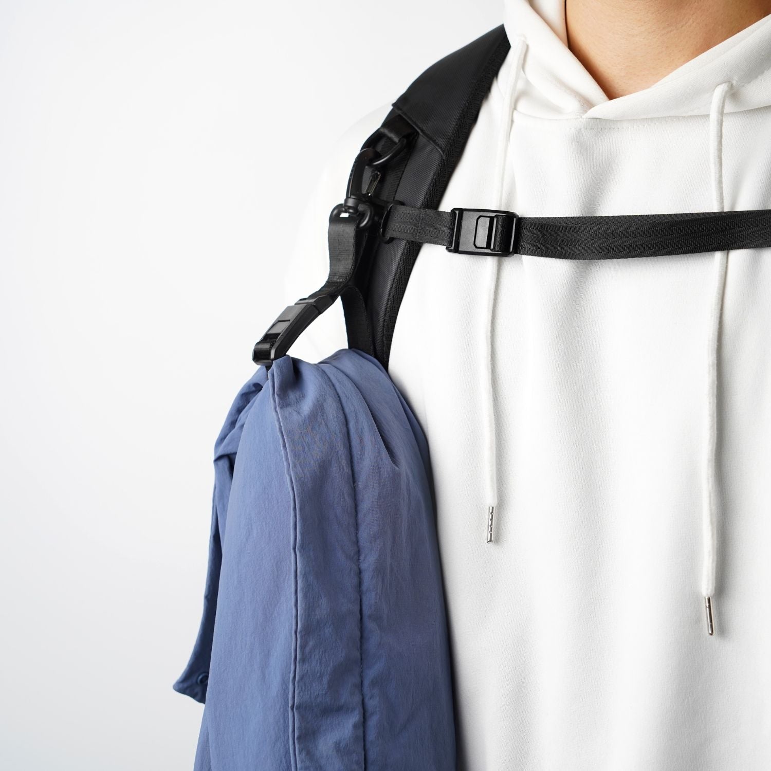 ADD1D Magnetic Gripper securing a folded jacket to a backpack shoulder strap