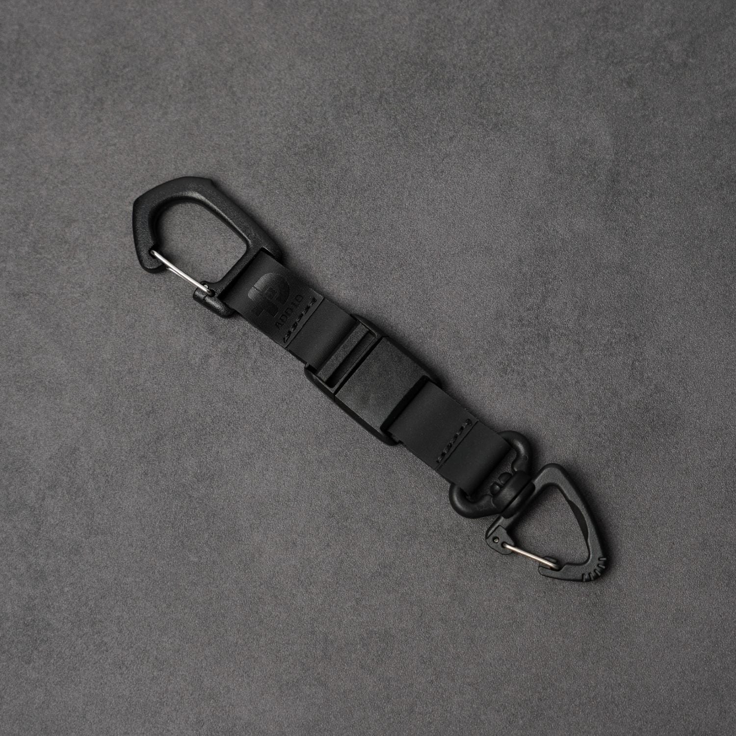 Black keychain with carabiners on a gray background