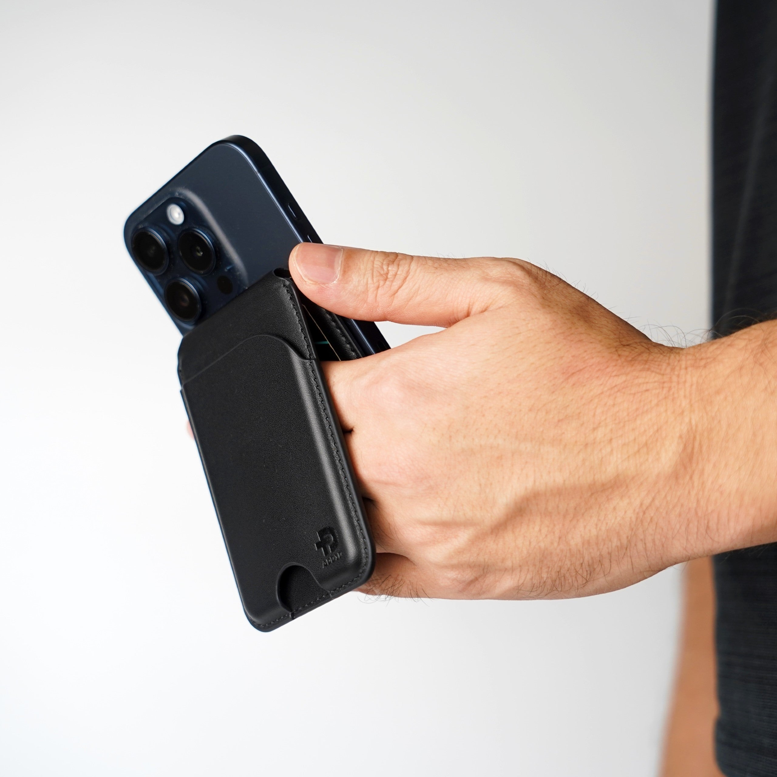 ADD1D Phone Stand Wallet held in hand showing ultra-thin profile and integrated phone grip strap